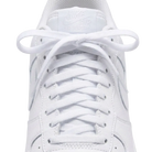 Close-up of a white Nike Air Force 1 sneaker showing the lace-up front, tongue branding, and side panels on a clean white background.